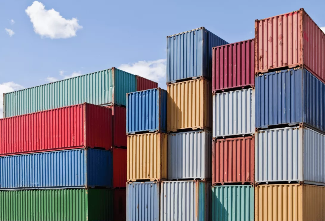 Colourful shipping container stacked and ready to be used.